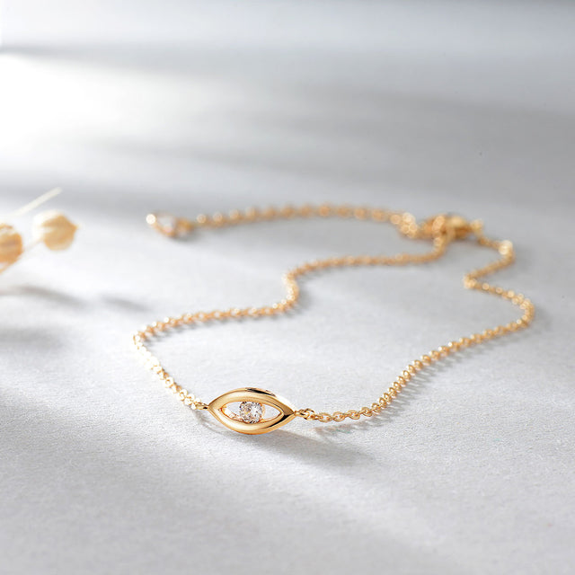 Close-up detail of Fettero® evil eye CZ chain bracelet, polished gold finish and sparkling cubic zirconia for women