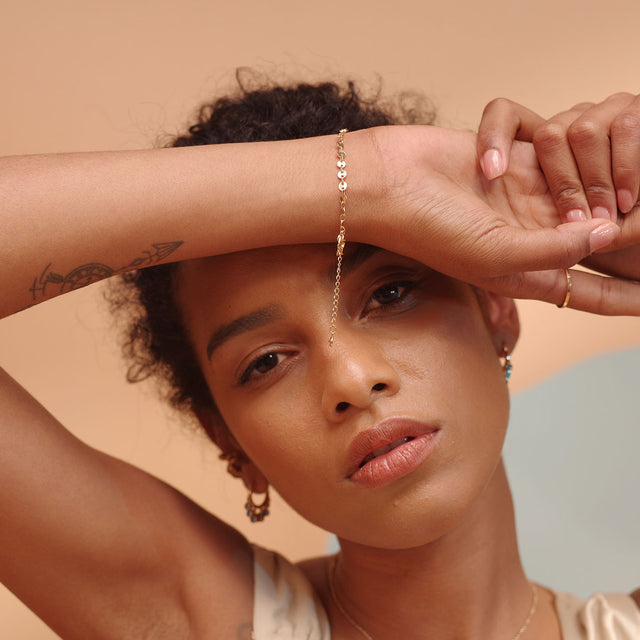 Model wearing Fettero® gold coin chain bracelet for women, delicate bracelet designed for everyday wea