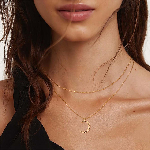 Model wearing Fettero® crescent moon gold necklace for women, delicate everyday wear jewelry with celestial charm