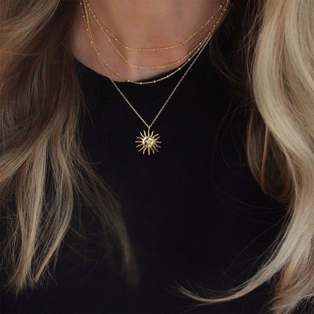 Evil Sun gold pendant necklace by FETTERO® styled on a woman, versatile piece for daily wear