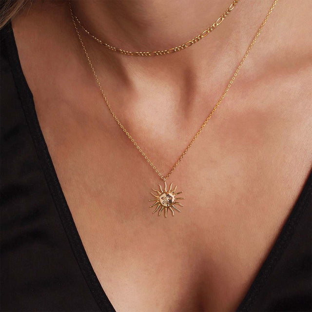 Woman wearing Evil Sun gold pendant necklace by FETTERO®, elegant everyday jewelry with symbolic sun design