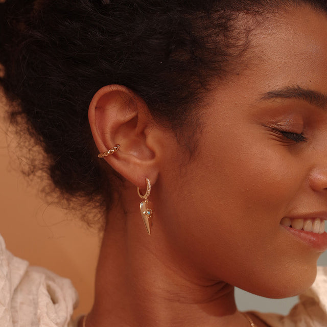 Woman wearing Fettero® heart eye gold dangle earrings, lightweight statement earrings with a modern charm