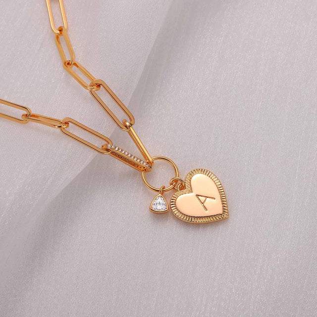 Close-up detail of Fettero® initial heart bracelet, polished gold finish with heart and initial charm design