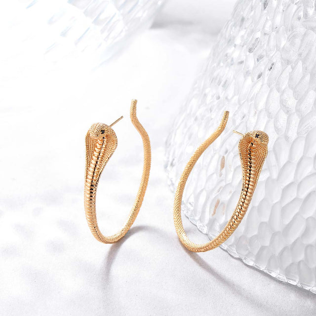 Close-up detail of Fettero® large snake hoop earrings, textured snake design with polished gold finish