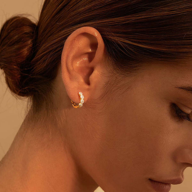 Model wearing Fettero® pavé CZ gold hoop earrings for women, chic everyday wear jewelry with a refined sparkle