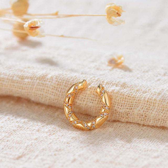 Close-up of Fettero® segmented ear cuff highlighting the layered segmented structure and polished gold finish