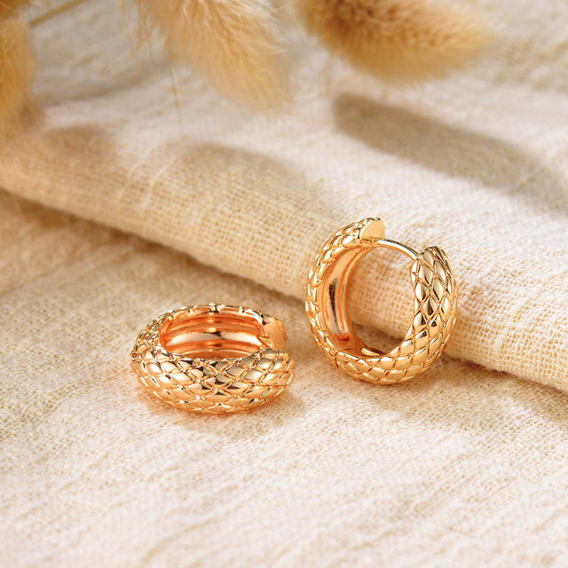 Close-up detail of Fettero® serpentine chunky hoop earrings featuring textured snake-inspired design and gold finish