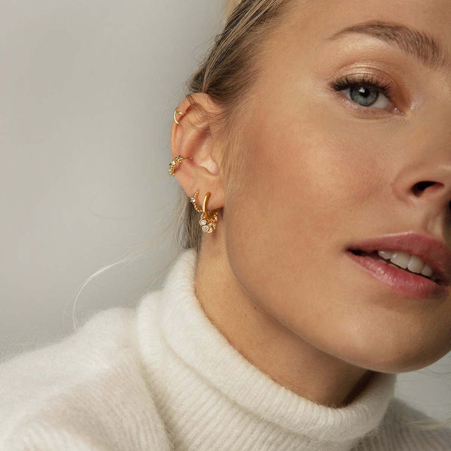 Fettero® white CZ dangle huggie earrings styled on model, gold earrings for women perfect for everyday wear and gifting