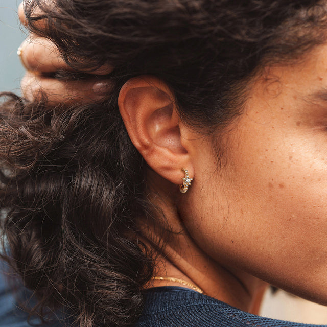 Fettero® CZ star huggie earrings styled on model, gold earrings for women perfect for everyday wear and gifting