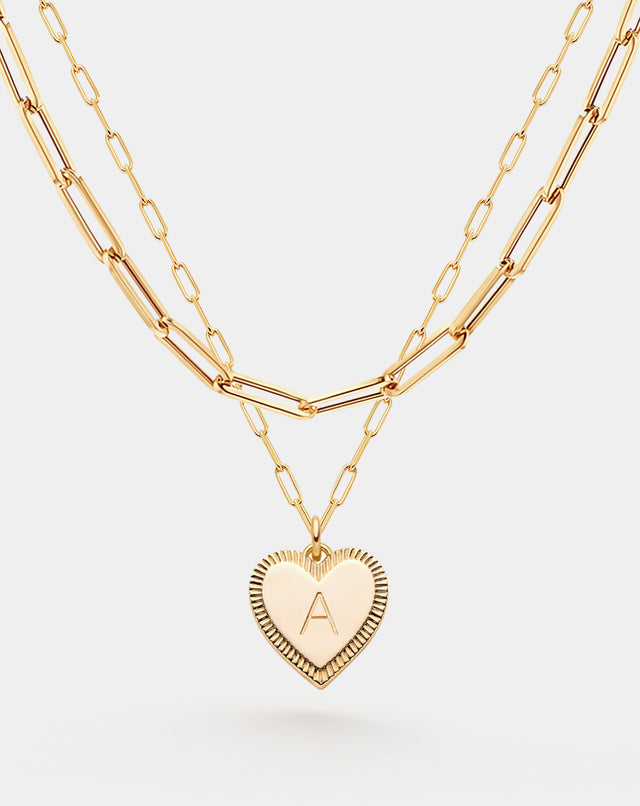 Close-up detail of Fettero® initial layered necklace, polished gold finish and personalized pendant design for women