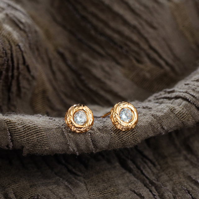 Close-up of Fettero® mini donut studs showing smooth circular design and polished gold finish
