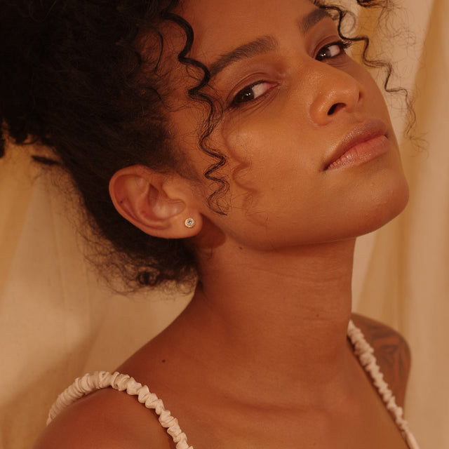 Fettero® mini donut stud earrings styled on a woman, subtle gold jewelry perfect for daily wear or a thoughtful gift