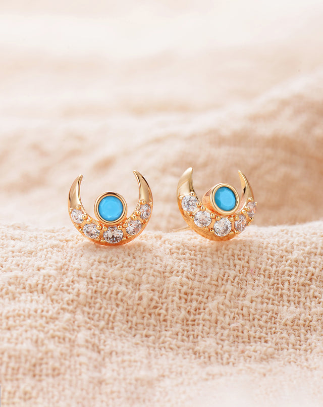 Close-up detail of Fettero® moon turquoise stud earrings, gold finish and turquoise stone craftsmanship for women