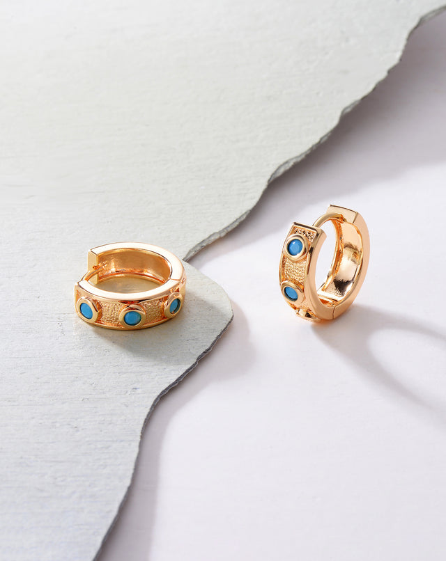 Close-up detail of Fettero® turquoise inlaid hoop earrings, polished gold with turquoise inlay craftsmanship for women