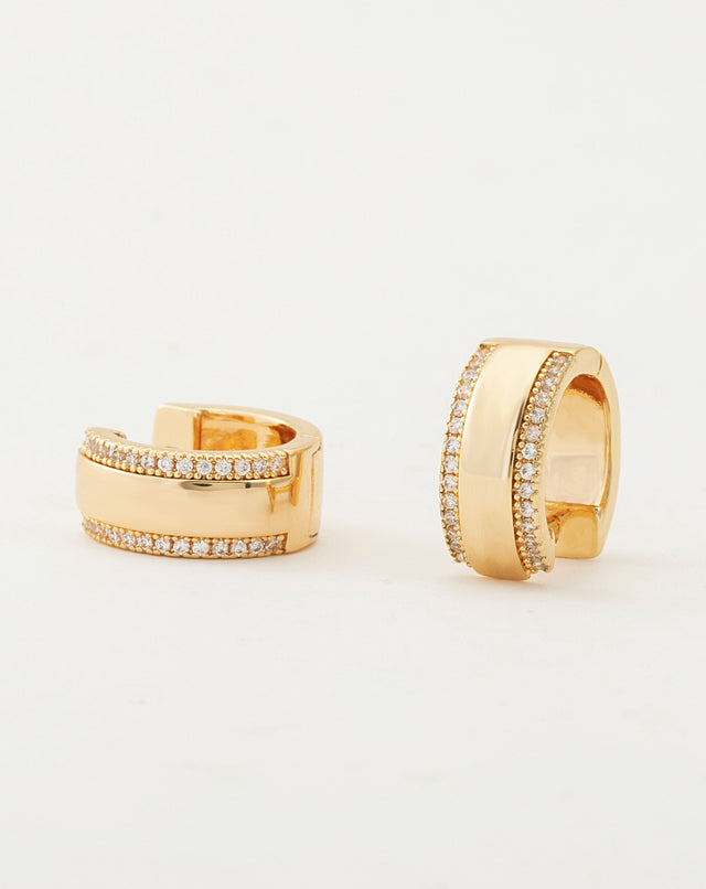 Close-up detail of Fettero® wide CZ huggie earrings, sparkling cubic zirconia and polished gold finish for women